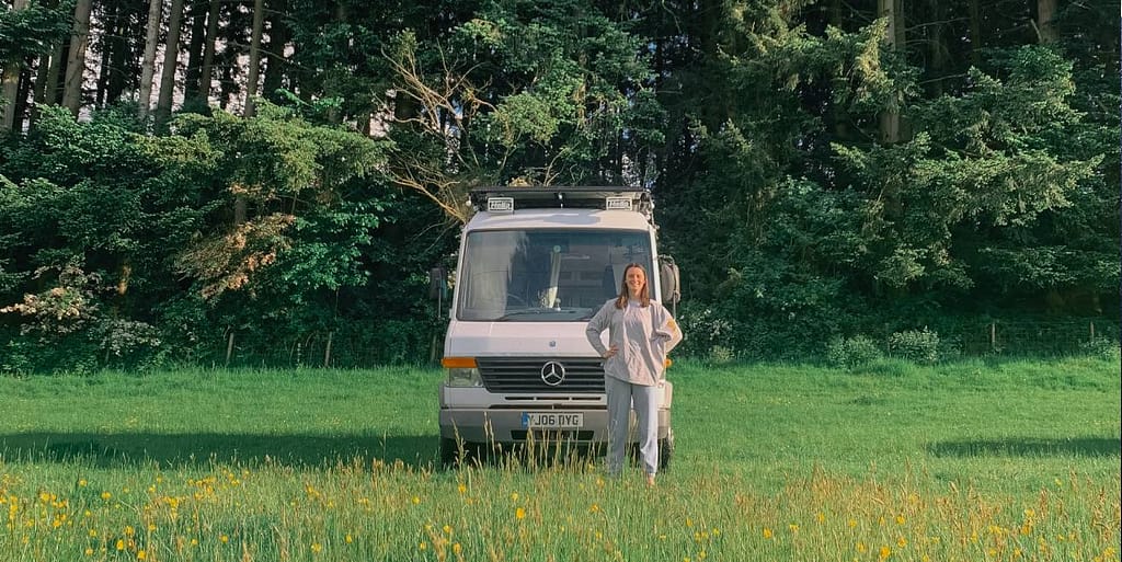 woman standing outside campervan