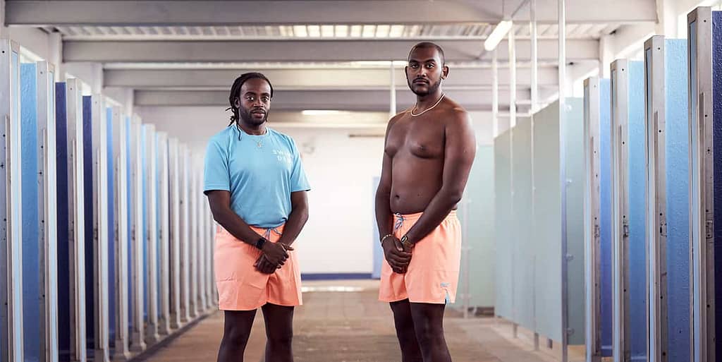 two male models wearing nike swim swimming shorts