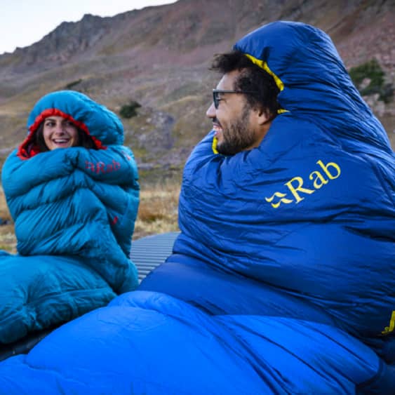 two people wrapped up in blue rab sleeping bags