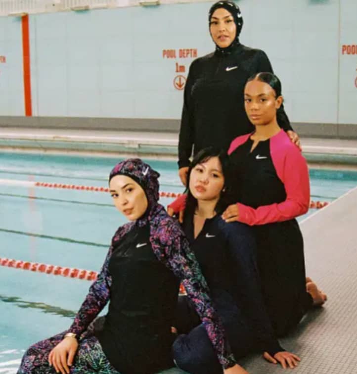 muslim sisterhood wearing nike swim swimwear by swimming pool