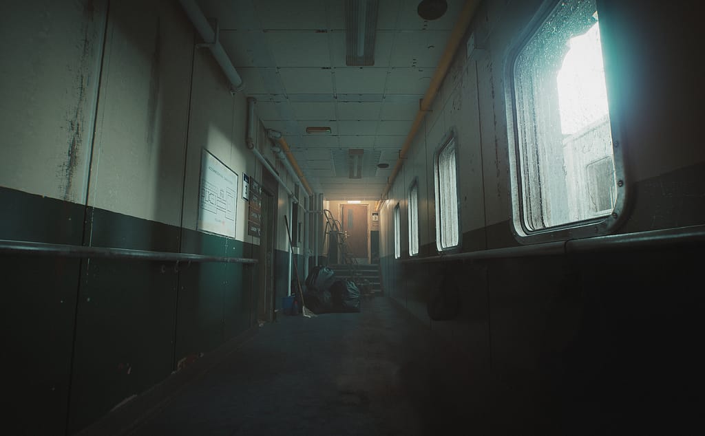 a screenshot from Still Wakes the Deep. Daylight pours in through the windows of an abandoned hallway.